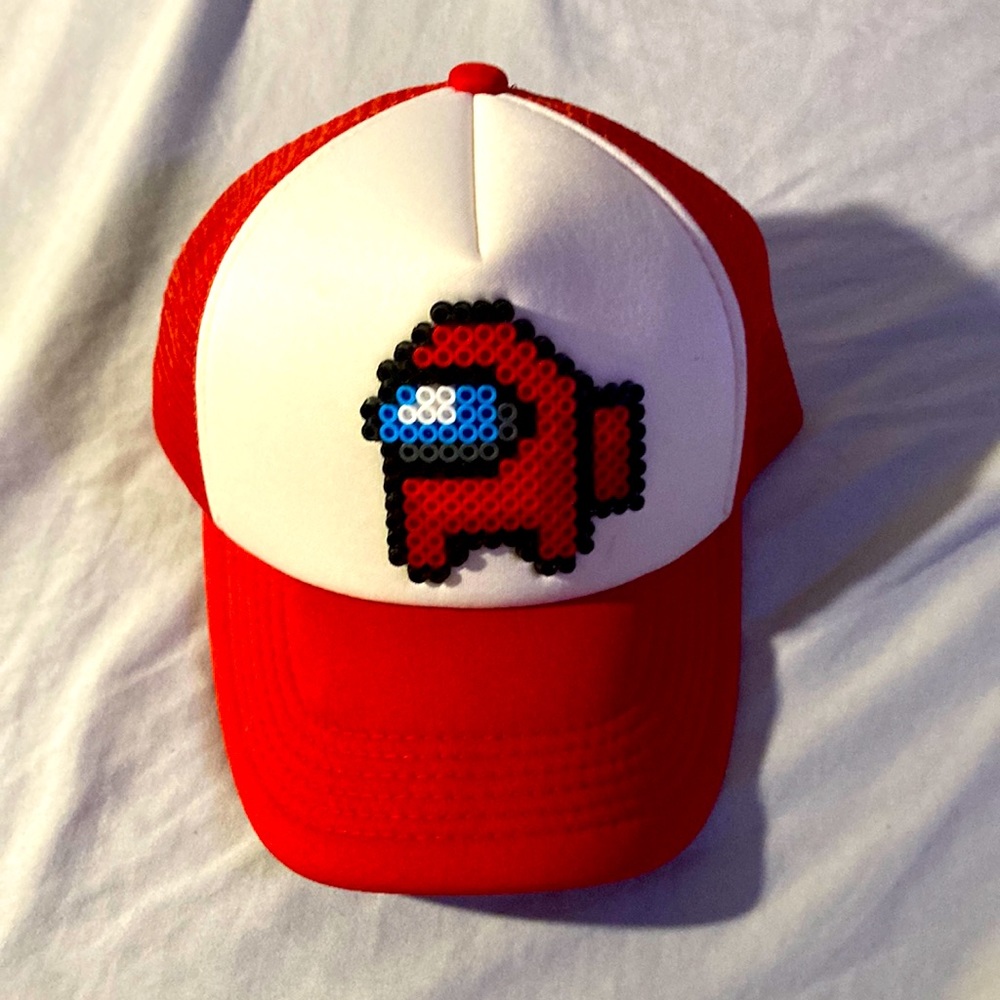 It's Red and White Cap with a Red among us person on the front